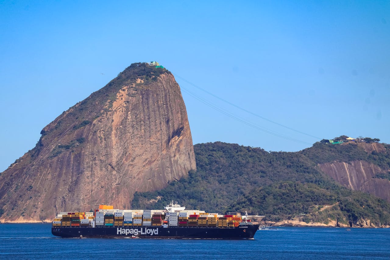 Navio cargueiro com contêineres e bandeiras do Brasil e dos Estados Unidos, simbolizando a retirada da tarifa de 40% dos EUA sobre produtos brasileiros do agronegócio.